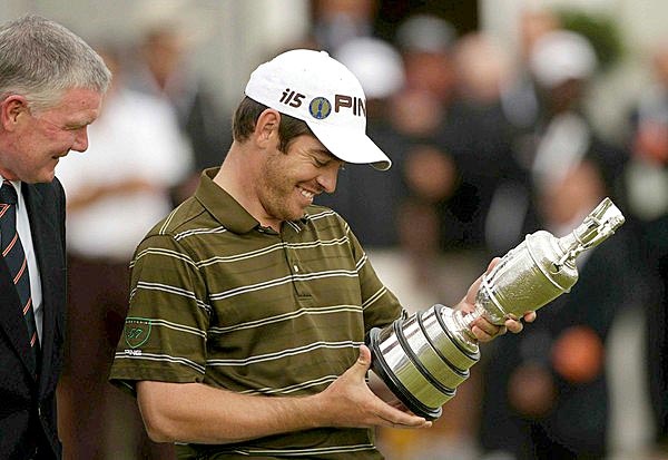 Louis Oosthuizen - 34 -of South Africa looks at some of the past winner's names on the Claret Jug after winning the 139th British Open on Sunday at St. Andrews